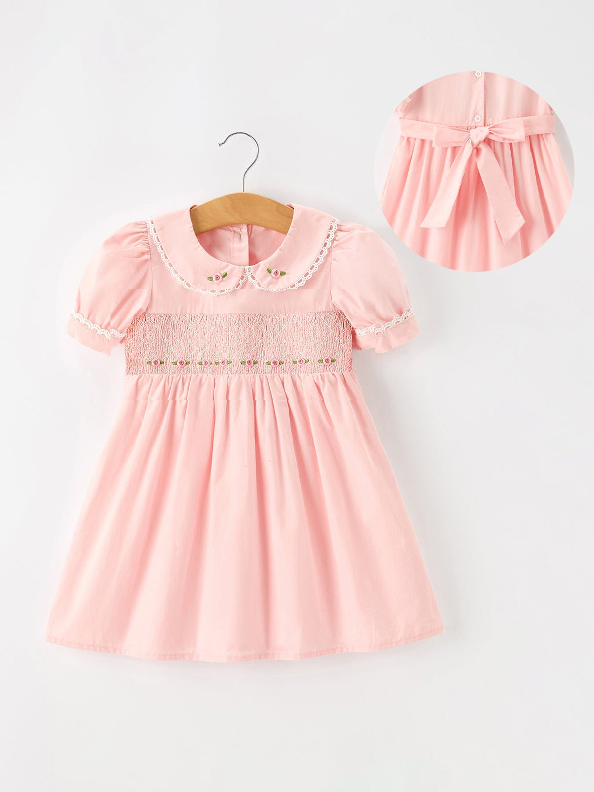 Girl wearing a pink floral embroidered smocked Rylee Faith Designs dress