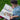 Young boy reading a colorful picture book outdoors, enjoying fun illustrations and storytelling.